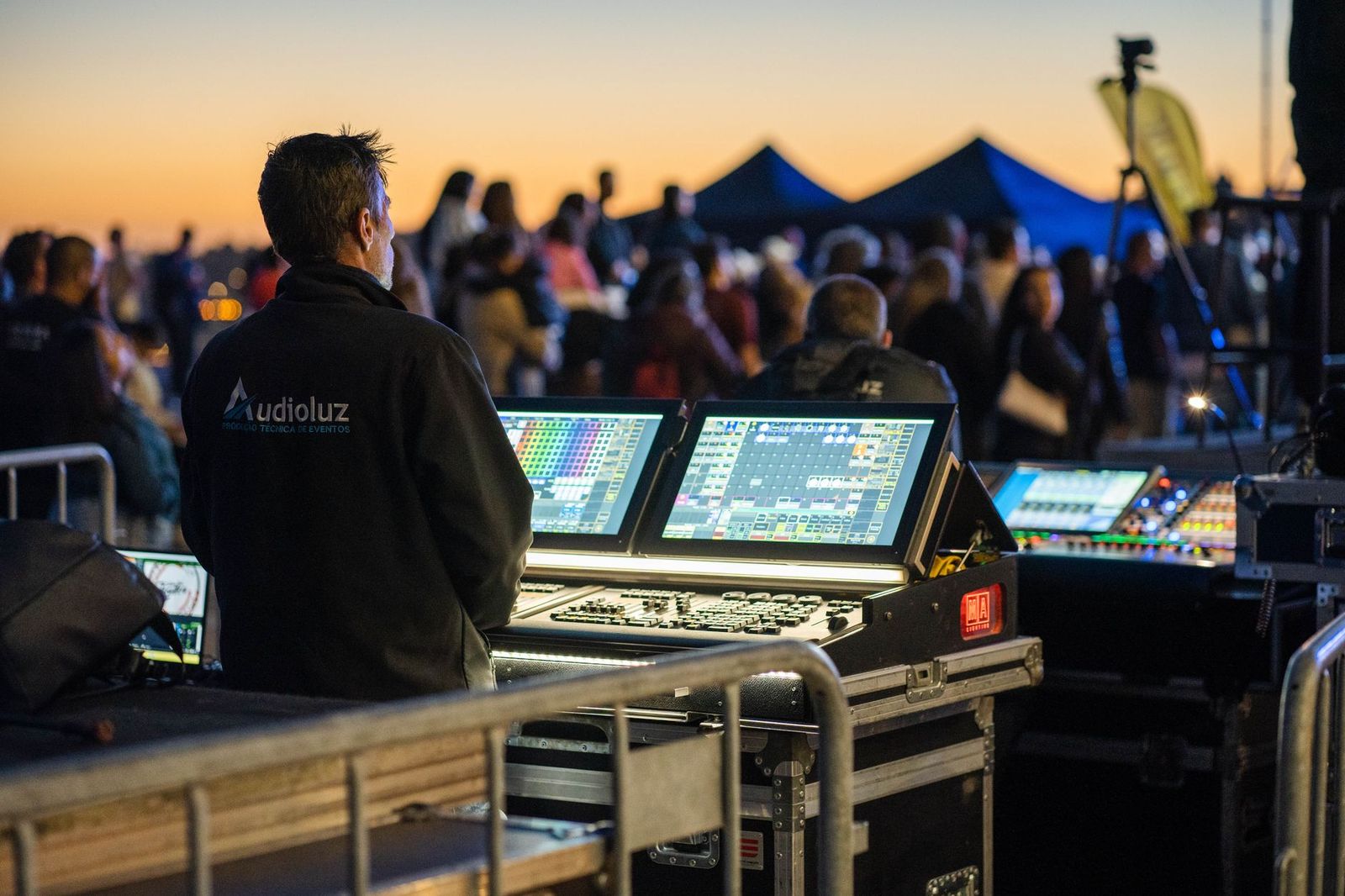 Festival production crew monitoring a show at night