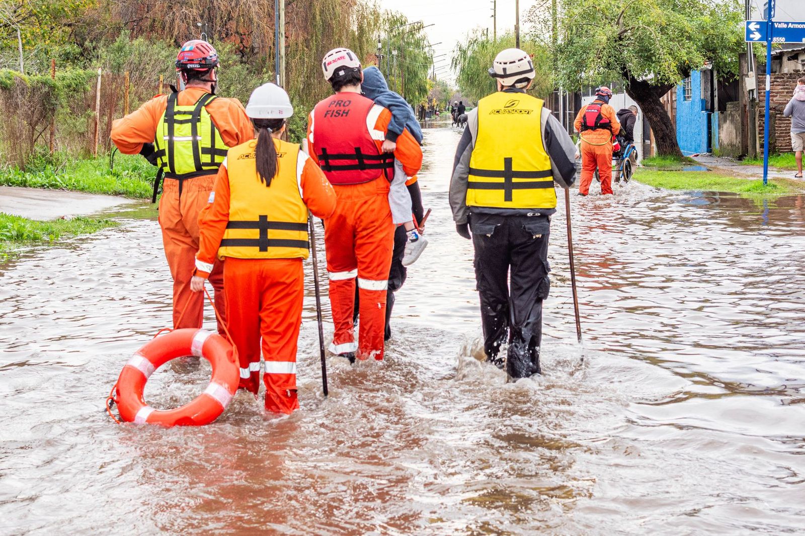 Flood disaster response crew wading through floodwater