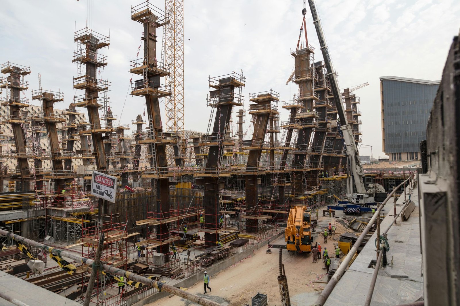 Construction crew and cranes at a large commercial jobsite