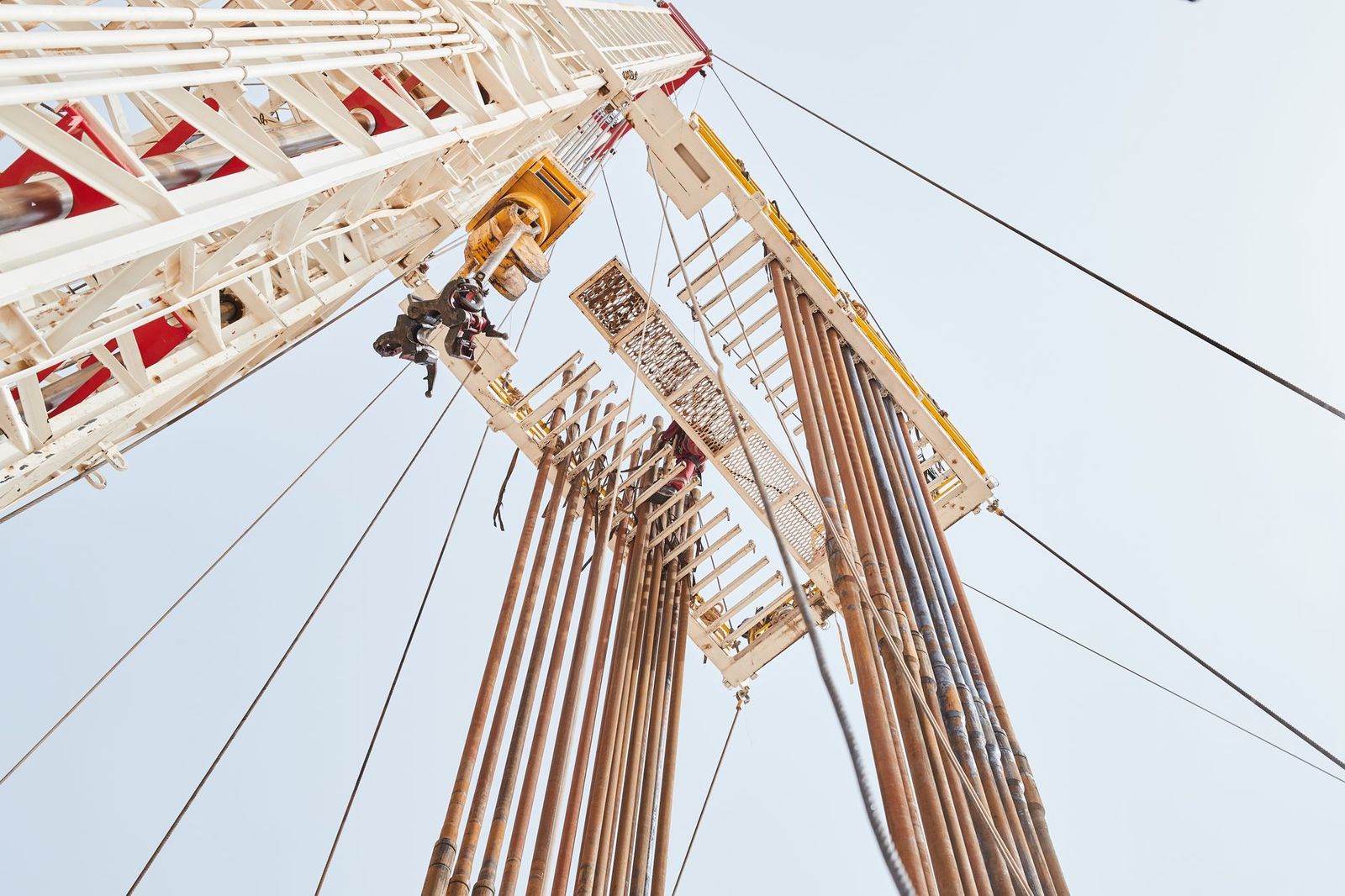 Oilfield drilling rig tower against the sky