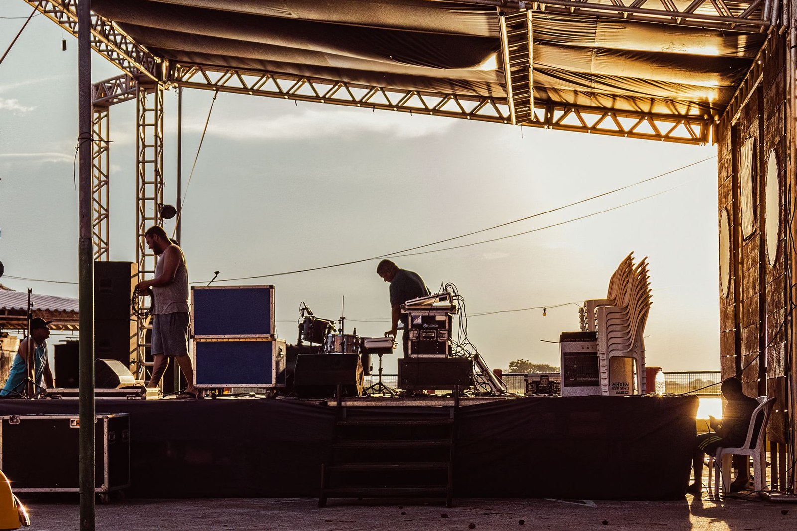 Festival production crew building the stage at golden hour