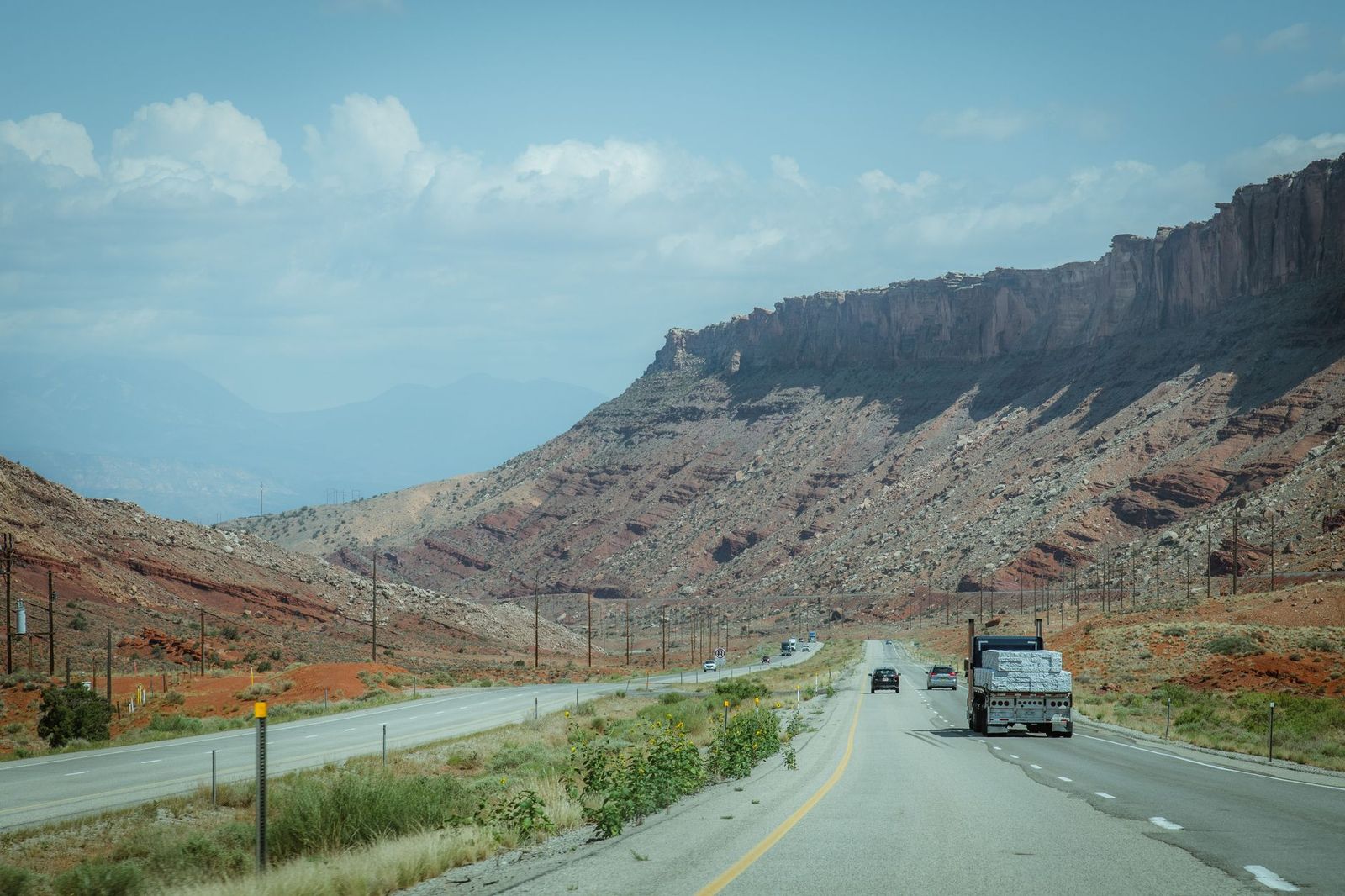 Two-lane highway running through a remote desert canyon in Utah