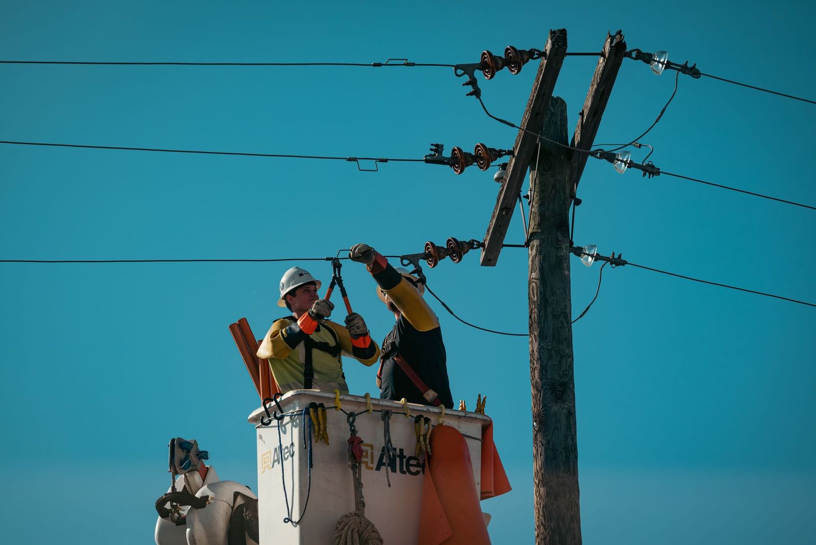 Utility linemen working a distribution pole