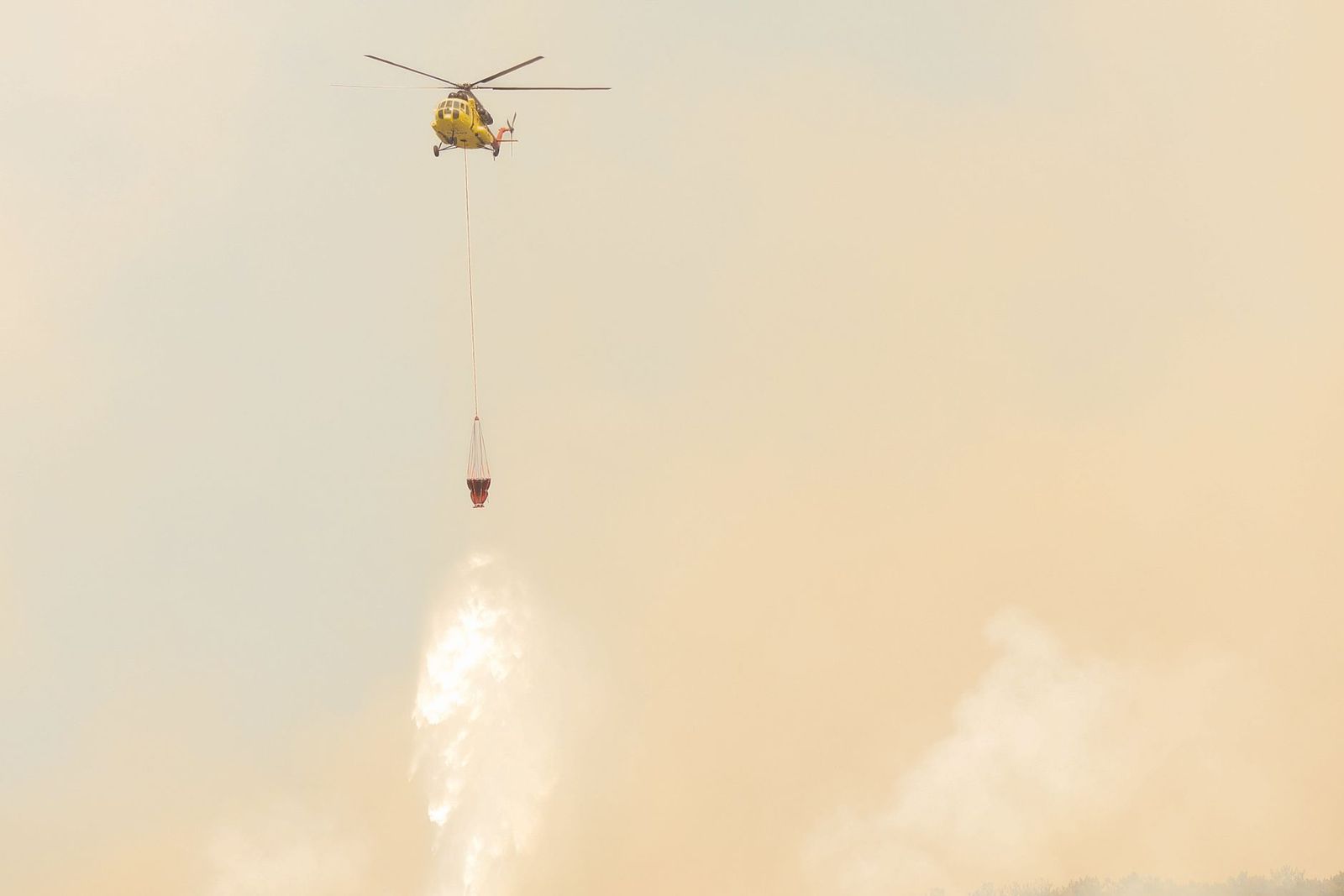 Firefighting helicopter making a water drop