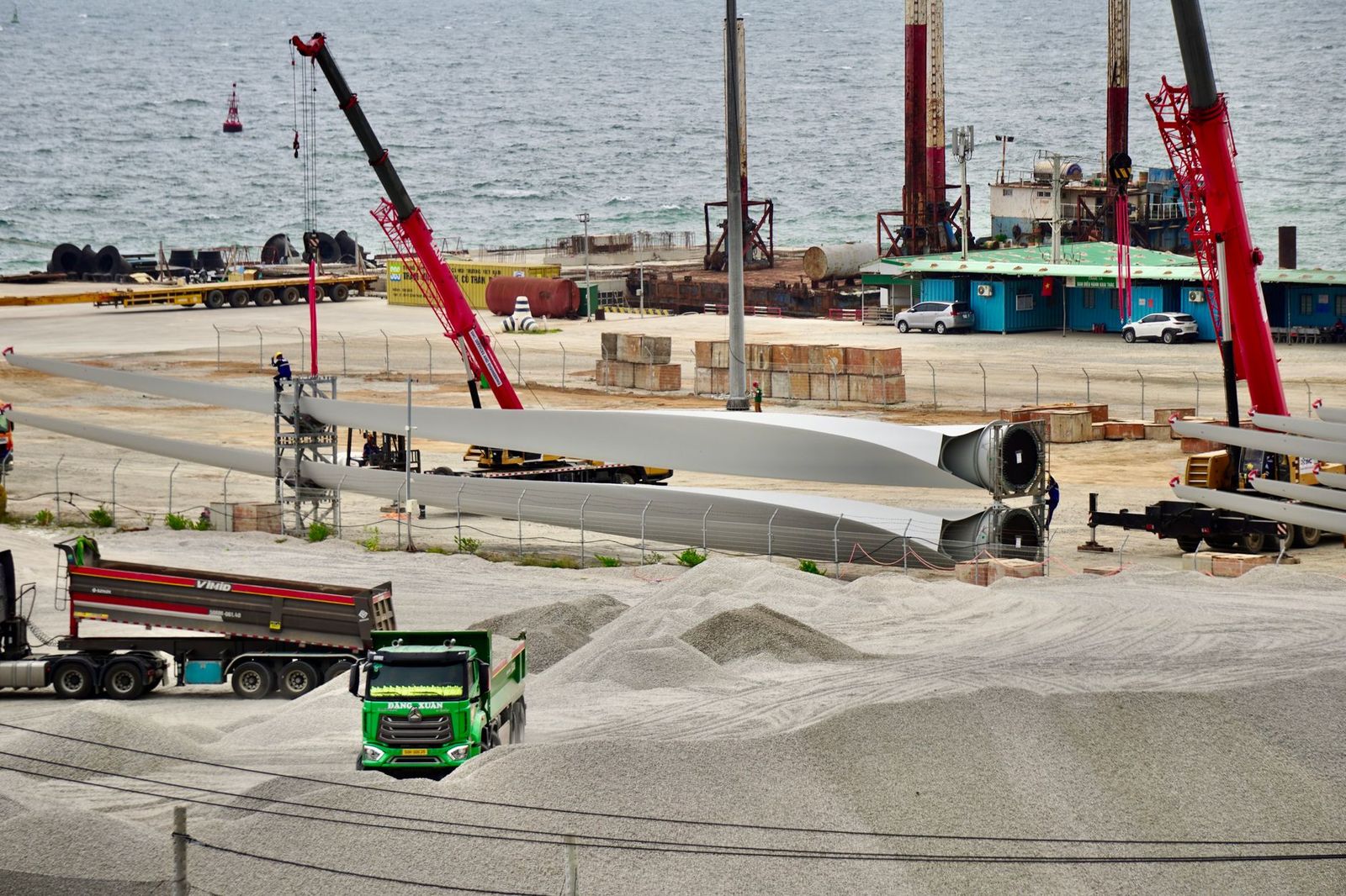 Wind turbine blade on a transport trailer at a construction yard